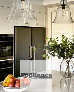 Freestanding side-by-side Liebherr fridge and freezer in a modern minimalist kitchen.