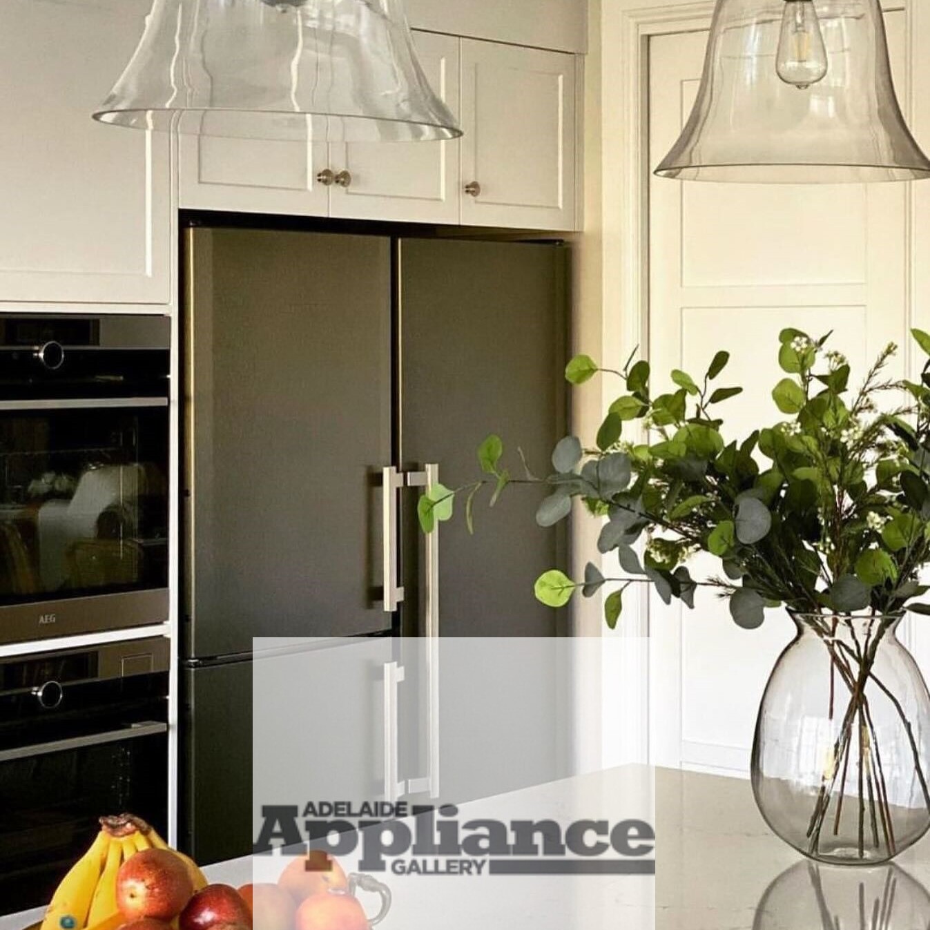 Freestanding side-by-side Liebherr fridge and freezer in a modern minimalist kitchen.